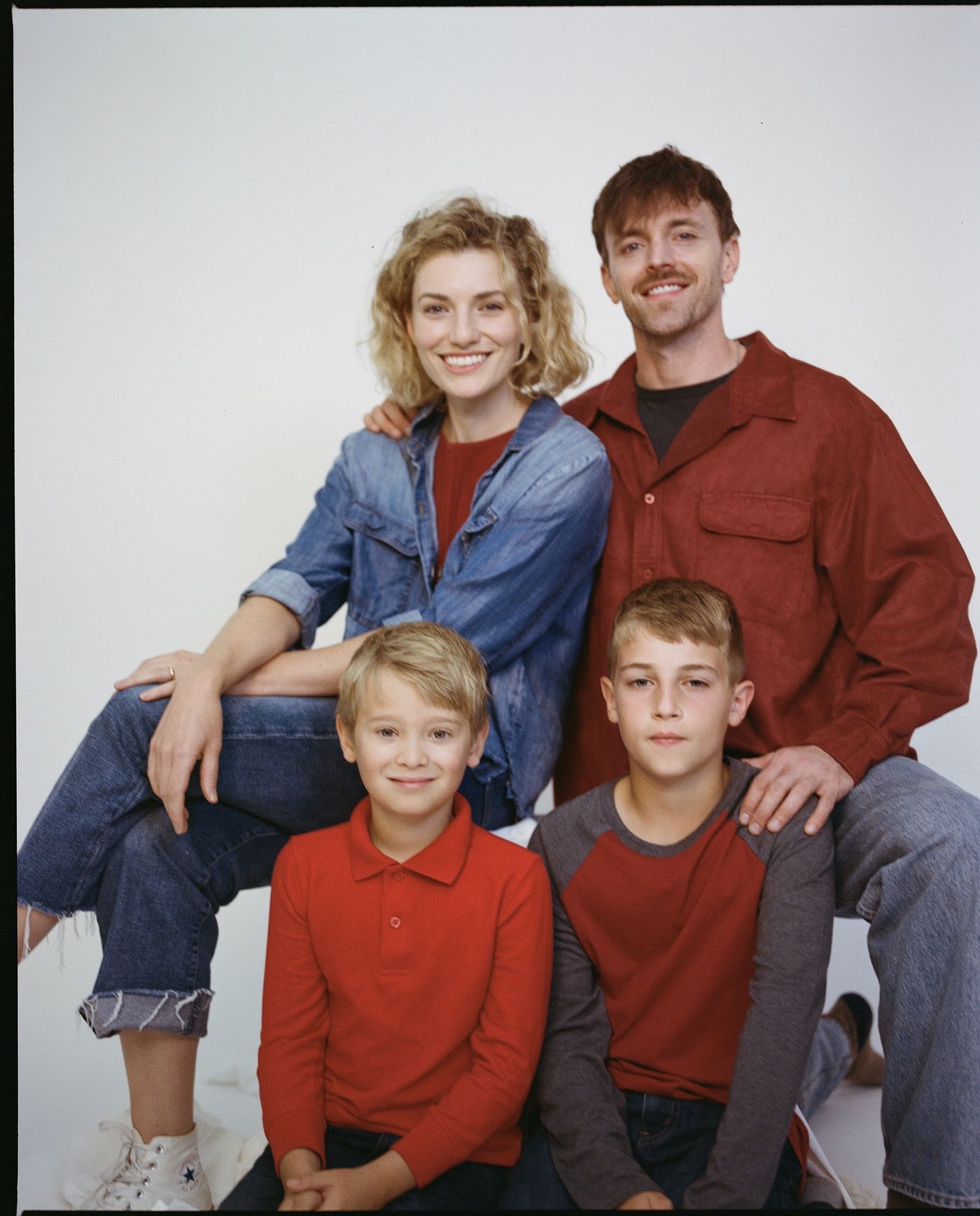 Studio portrait of the family in red and denim.